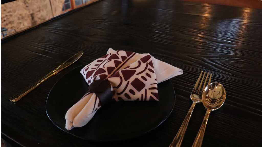 Napkin on a table with gold utensils